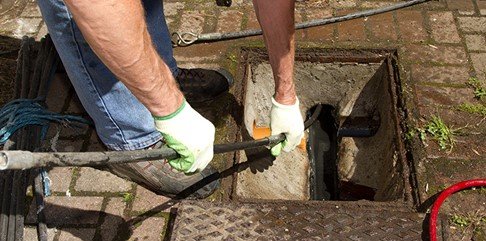 Titan Drain Services engineer carrying out planned preventative drain maintenance at a commercial site